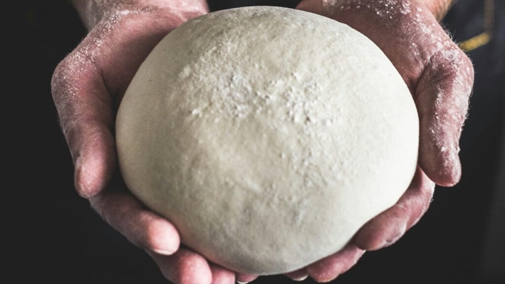 pizza dough with flour on top
